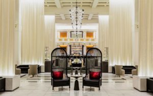 large hotel lobby with two iron chairs in the center