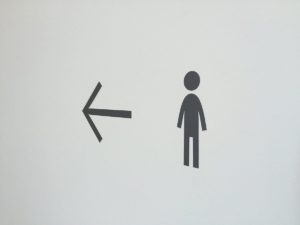 two icons of an arrow pointing left with a person to the right of it
