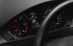 closeup of a car dashboard showing the speedometer