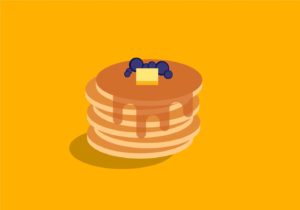 A stack of pancakes with syrup, blueberries and butter on top.