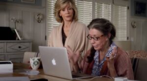 older women using a computer in the kitchen